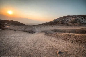 Sunset over Death Valley. A road curves into the Artist’s Palette Drive, with the salt flats of Badwater Basin beyond.