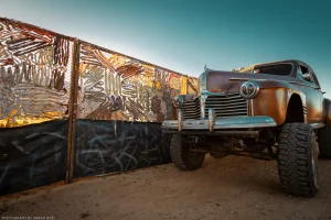 A theme-appropriate vehicle parked at the build site of post-apocalyptic festival Wasteland Weekend.