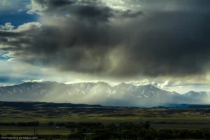 Rays of light through rain mist clouds over the Crazy Mountains near Big Timber, Montana.