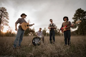 A twilight group shot of former bluegrass band Dodgy Mountain Men, taken during the music video shoot for “Gone Gone Gone.”