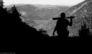 A silhouetted, black and white portrait of photographer Chris Balboni on a hike in the Cabinet Mountains.