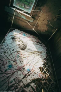 Late afternoon sun filters into an abandoned guest room at the Wells Hotel in the ghost town of Garnet, Montana.