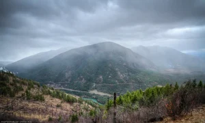 A rainy, early autumn view across the Kootenai River gorge at Grambauer Mountain near Troy, Montana.