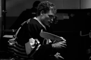 Sam Martel, then of the Bismarck Bobcats, makes some tape adjustments in moody black and white.