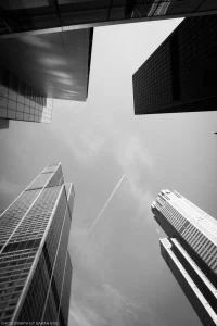 A dramatic, low-angle shot of the empty sky between iconic Chicago buildings (of which includes the Sears/Willis Tower).