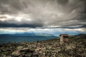 Clouds at nearly eye-level, swirling above an outhouse on Northwest Peak in far northwest Montana.