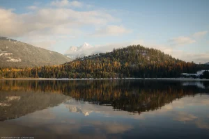 A reflective waterscape on Bull Lake (northwest Montana), equal parts autumn and winter.