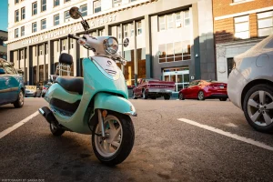 An aesthetically pleasing, cream-and-aqua scooter parked in the downtown area of Burlington, Iowa.